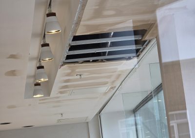 Scaffold tower set up beneath flood-damaged ceiling void in NEXT store, Eastbourne