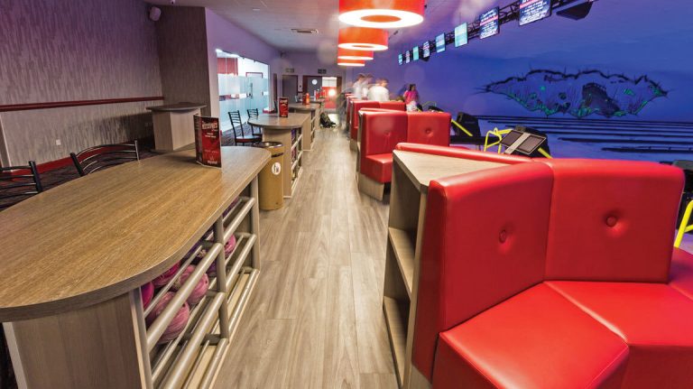 Red upholstered booth seating with laminate storage units and shoe racking, bespoke joinery manufactured and fitted by Central Shop Maintenance at a Superbowl bowling venue