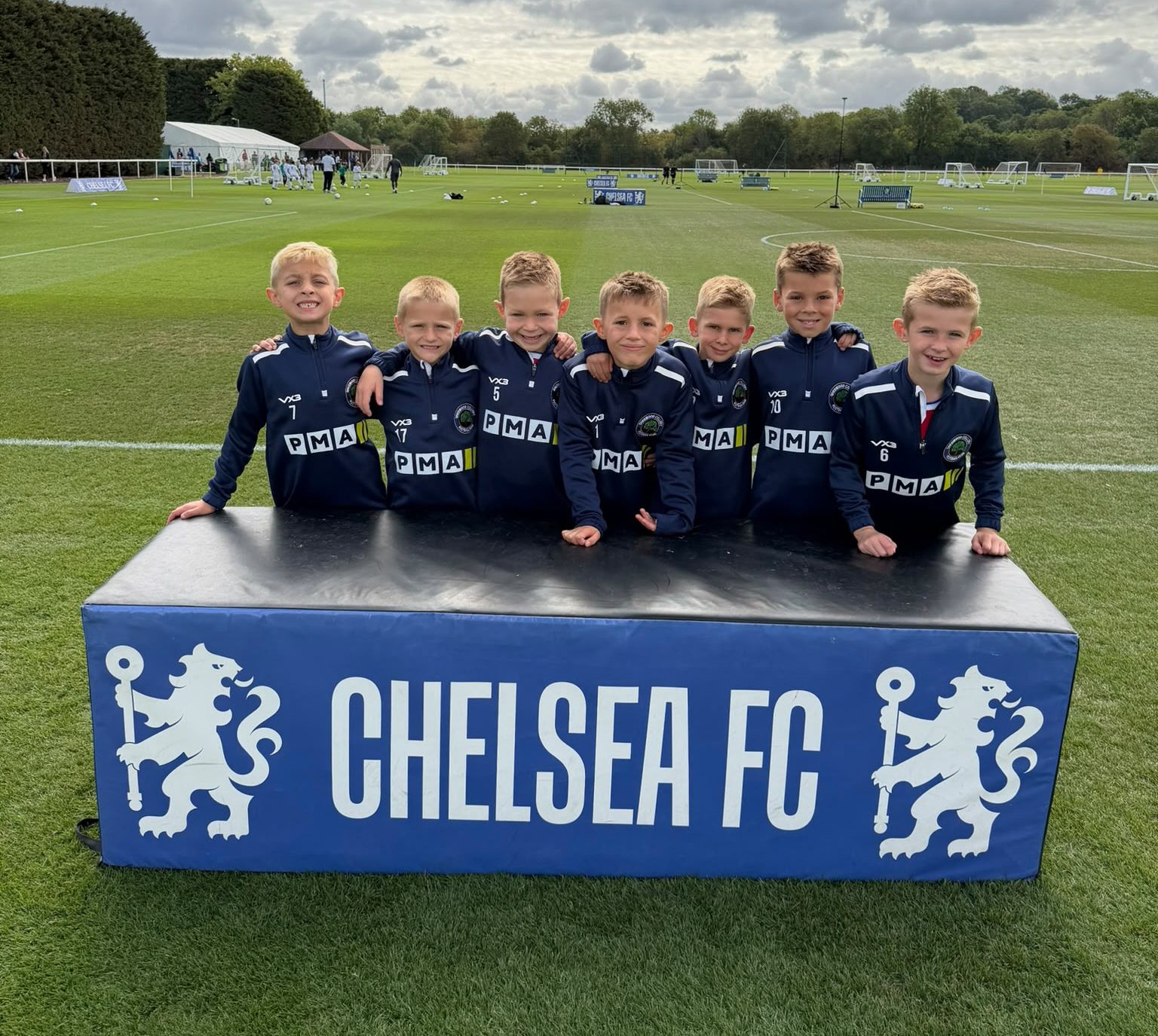 Sherwood Colliery Stags U8s players in PMA-sponsored training kit at Chelsea FC's Cobham training ground