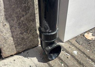 New downpipe base close-up at Summerwood Vets Blackwood