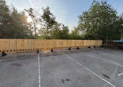 New timber fence around vet surgery car park at sunrise
