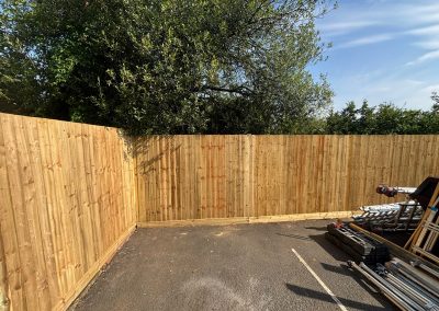 New timber boundary fence with scaffolding and tools on site